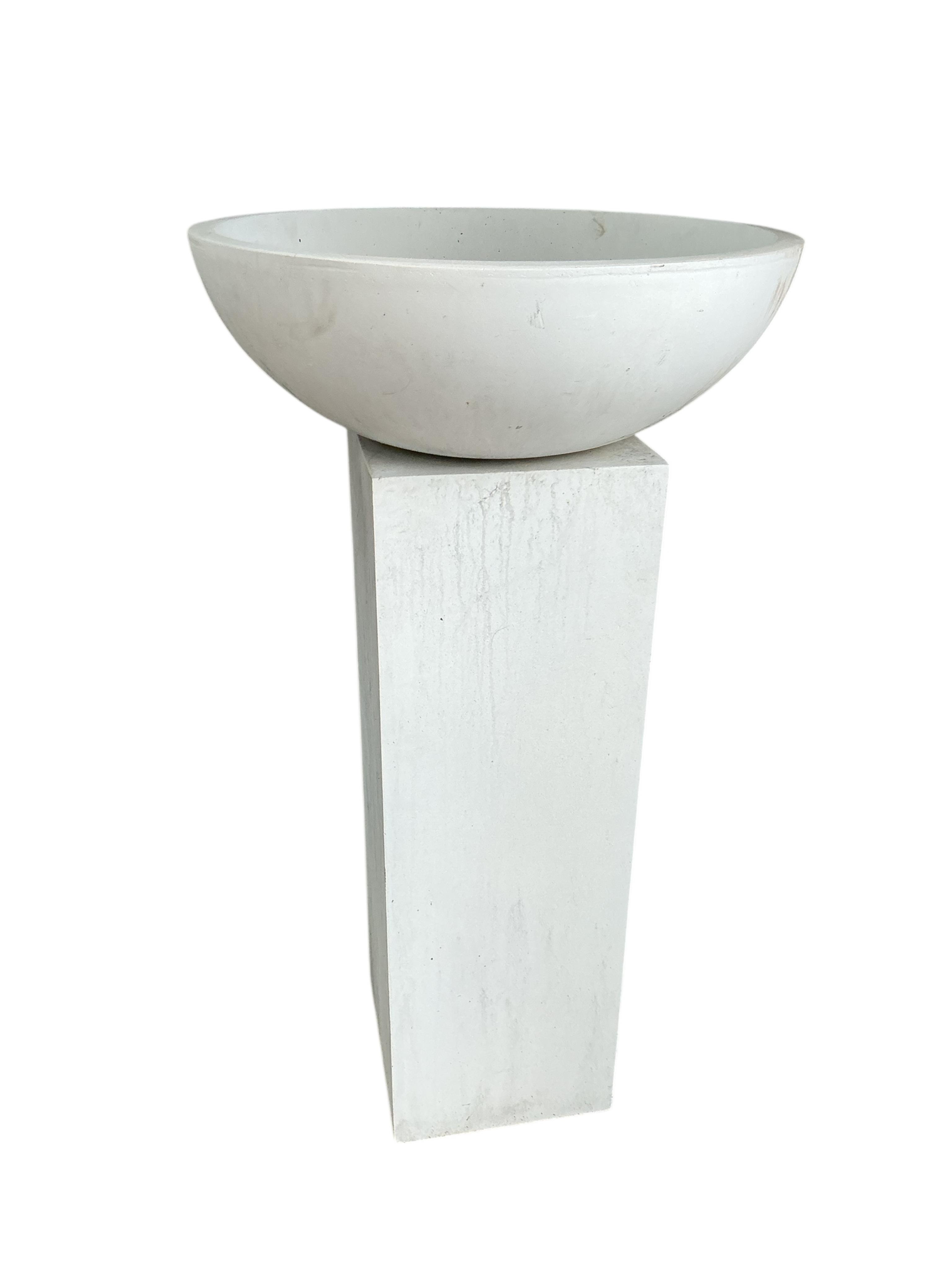 A pair of contemporary circular composition planters on square pedestal bases, diameter 60cm, height 112cm